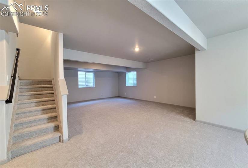 Spacious Family room and game area boasts 9' ceilings and is prepped for a future wet bar!