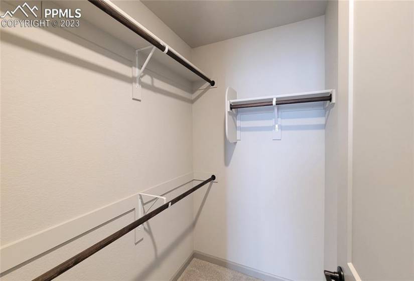 4th Bedroom's walk-in closet with wood shelving and rods!