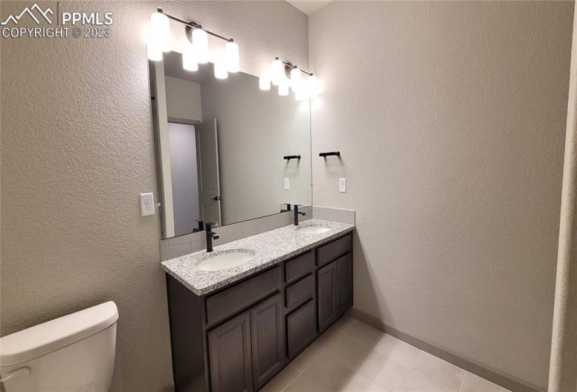 Full Bathroom with double vanities, located in the lower-level!
